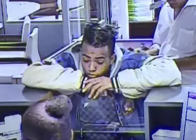 The rapper was getting money out to purchase a motorbike.