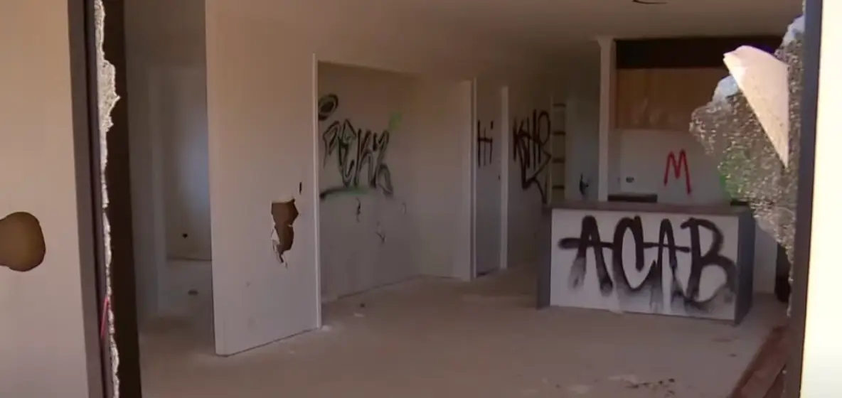 Images show smashed windows and graffiti in the home.