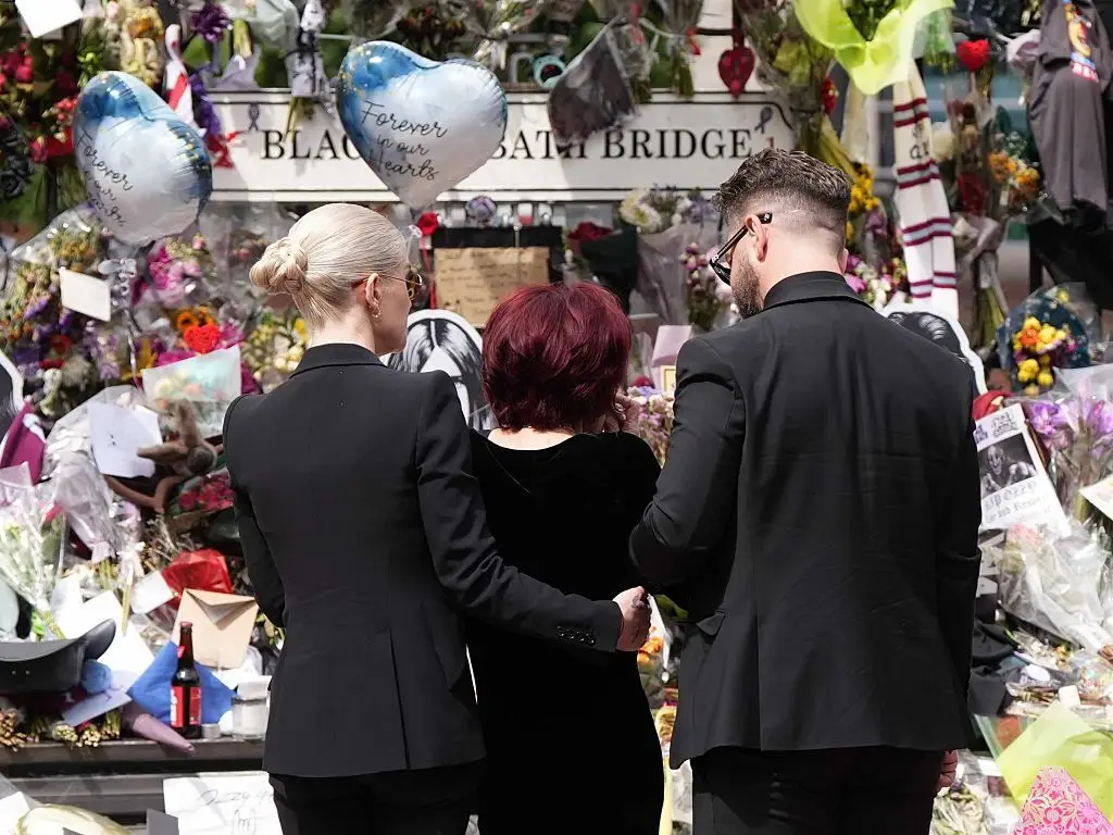 Sharon Osbourne was supported by children Jack and Kelly as they placed floral tributes to the late Ozzy Osbourne in Birmingham, UK (Loannis Alexopoulos/Anadolu via Getty Images)