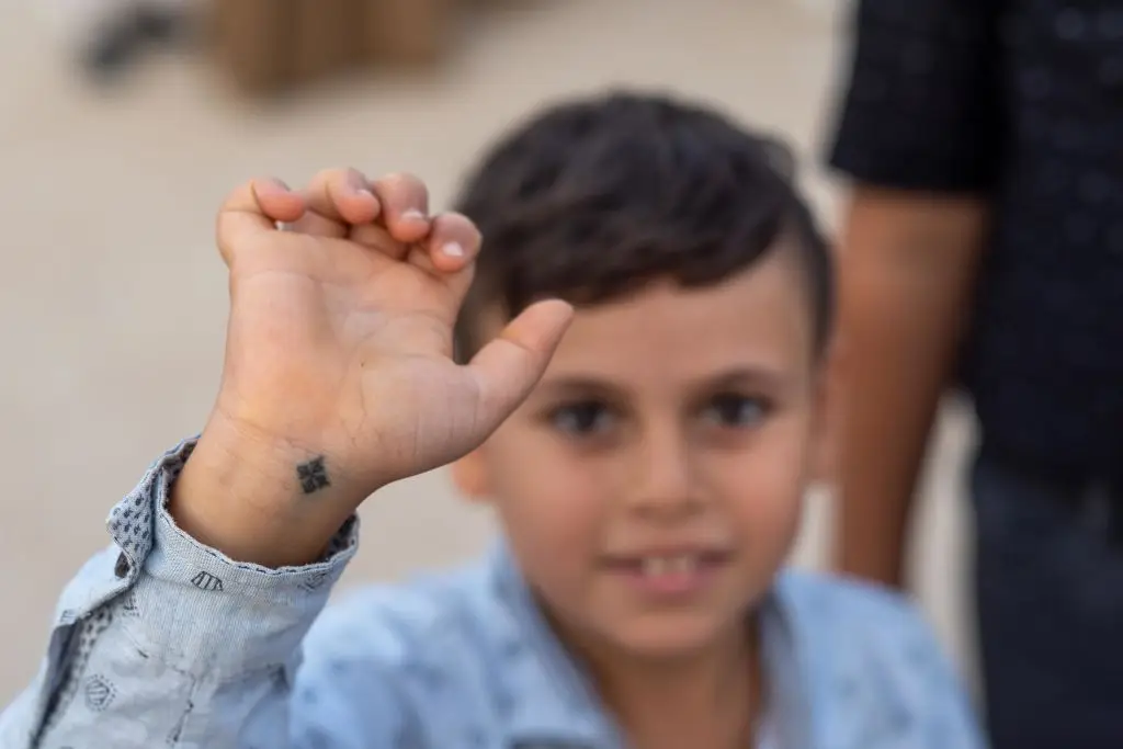 In Egypt, Coptic Christians tattoo children with a symbol of their faith, but the practice is illegal in Kentucky (Roger Anis/Getty Images)