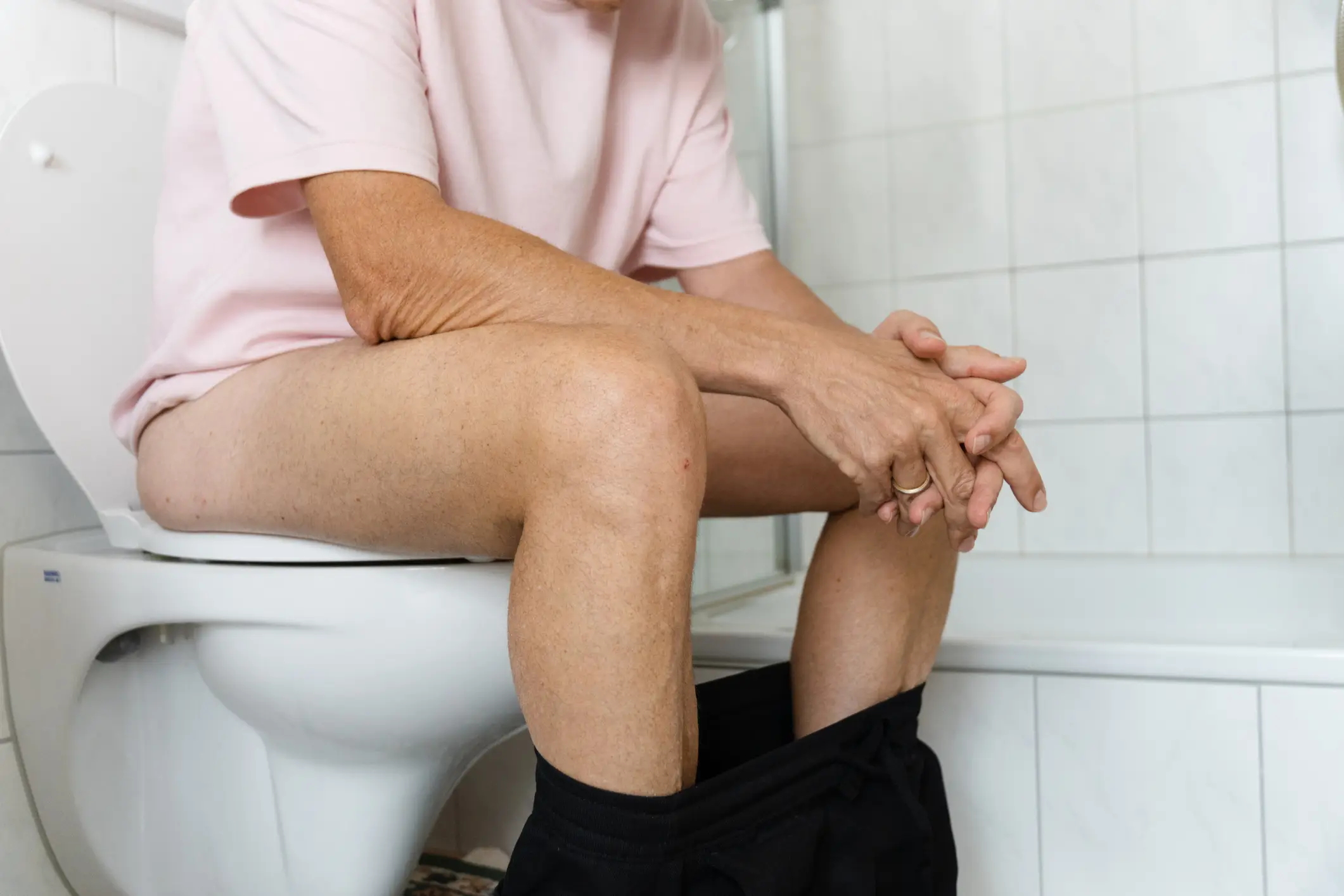 A man sitting on a toilet peeing (Getty Images)