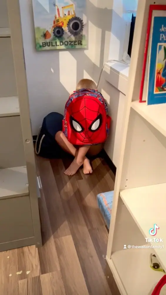 Weston shows how he'd hide behind his backpack.