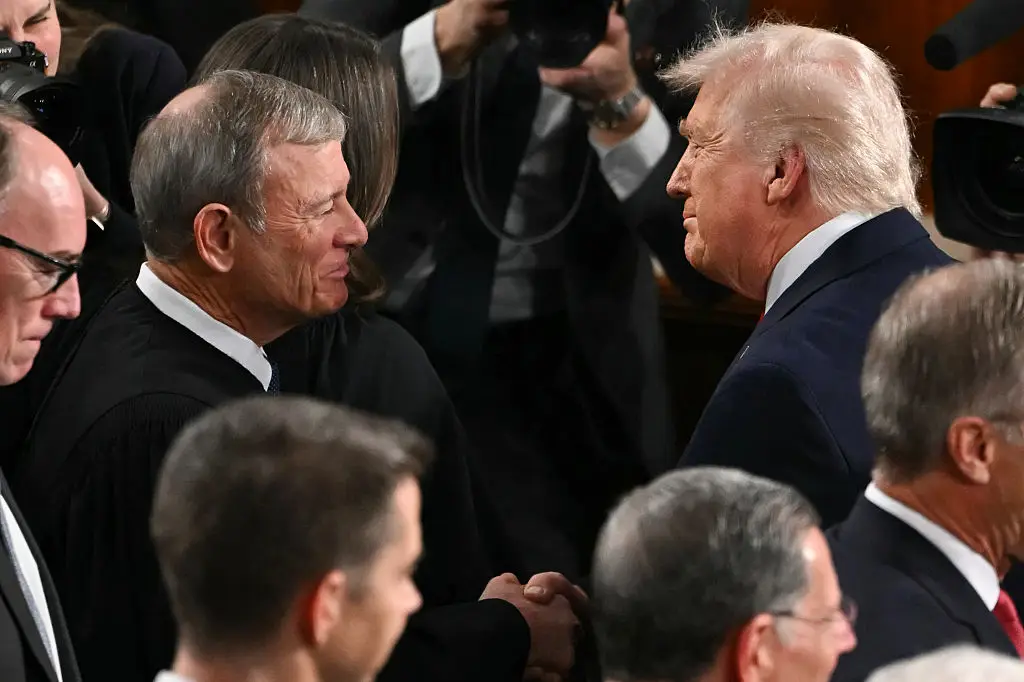 US President Donald Trump shakes hands with Supreme Court Chief Justice John Roberts (ANDREW CABALLERO-REYNOLDS / AFP via Getty Images)