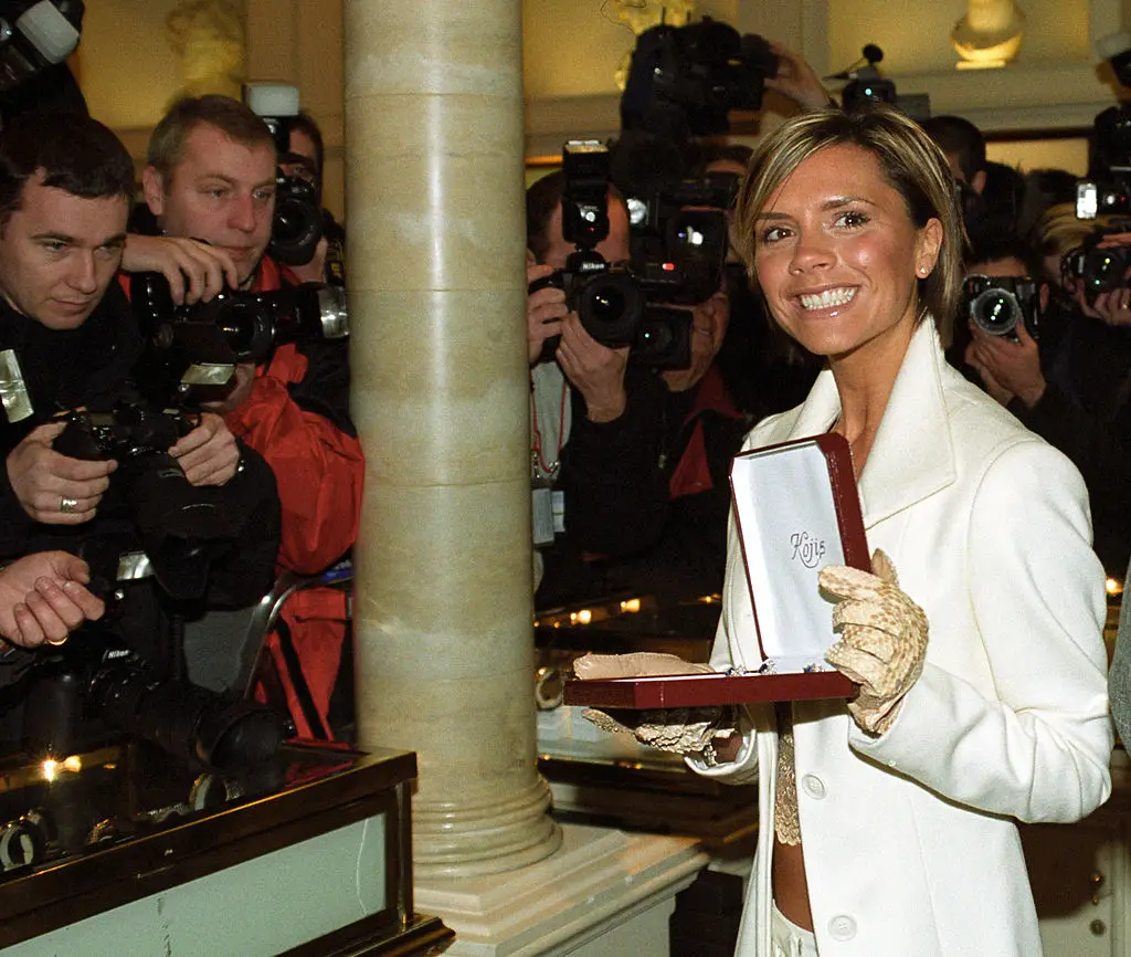 Victoria donning a rare smile while opening the Harrods sale in London back in 2002 (Ferdaus Shamim/WireImage)