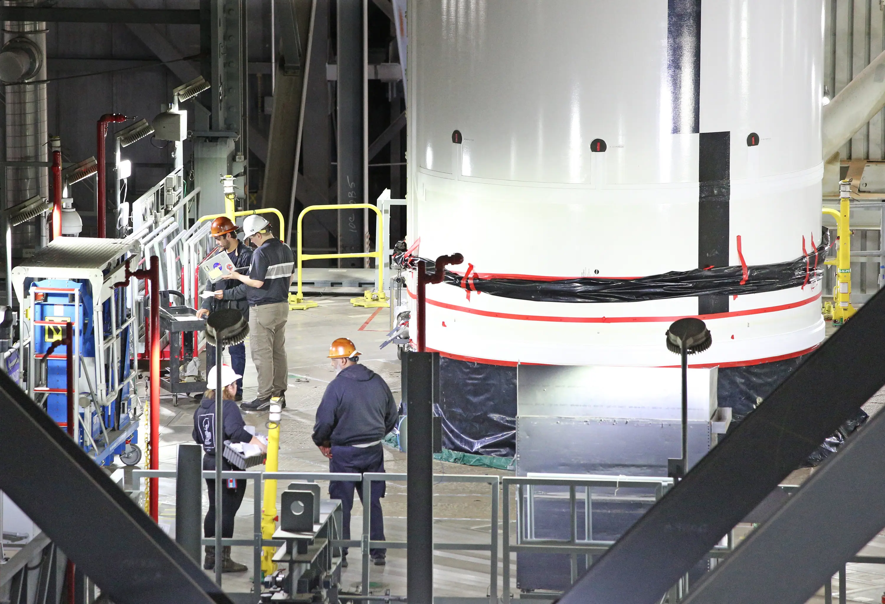 NASA engineers seen working by the Artemis II Space Launch System (GREGG NEWTON/AFP via Getty Images)