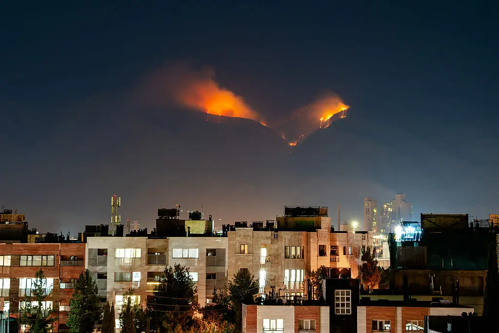 Smoke and flames can be seen at an alleged nuclear site in the mountains of Shiraz, Iran (HIROON/Middle East Images/AFP via Getty Images)
