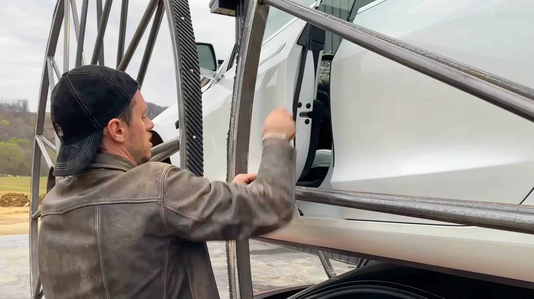 The YouTuber did struggle to get into the modified Tesla (@whistlindiesel/YouTube)