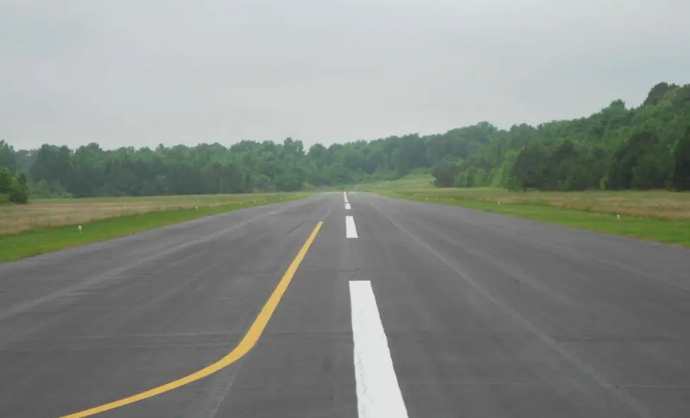 Samantha Hayes was riding the lawnmower by the runway.