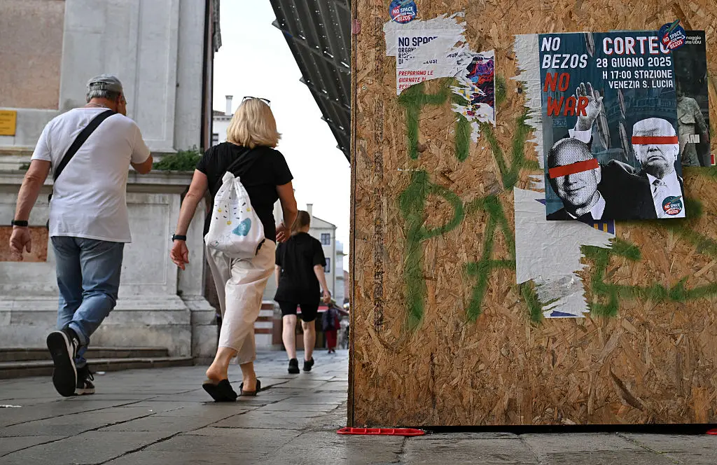 Posters could be seen plastered all over the city (STEFANO RELLANDINI/AFP via Getty Images)