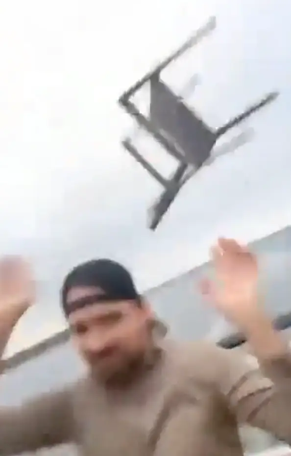 Chairs can be seen going flying.