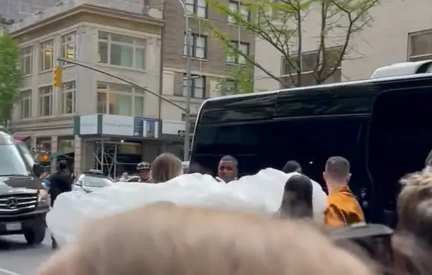 The cocooned celebrity was carried out of the hotel and onto the Met Gala.