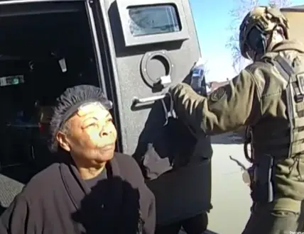 Johnson in the back of a police vehicle.