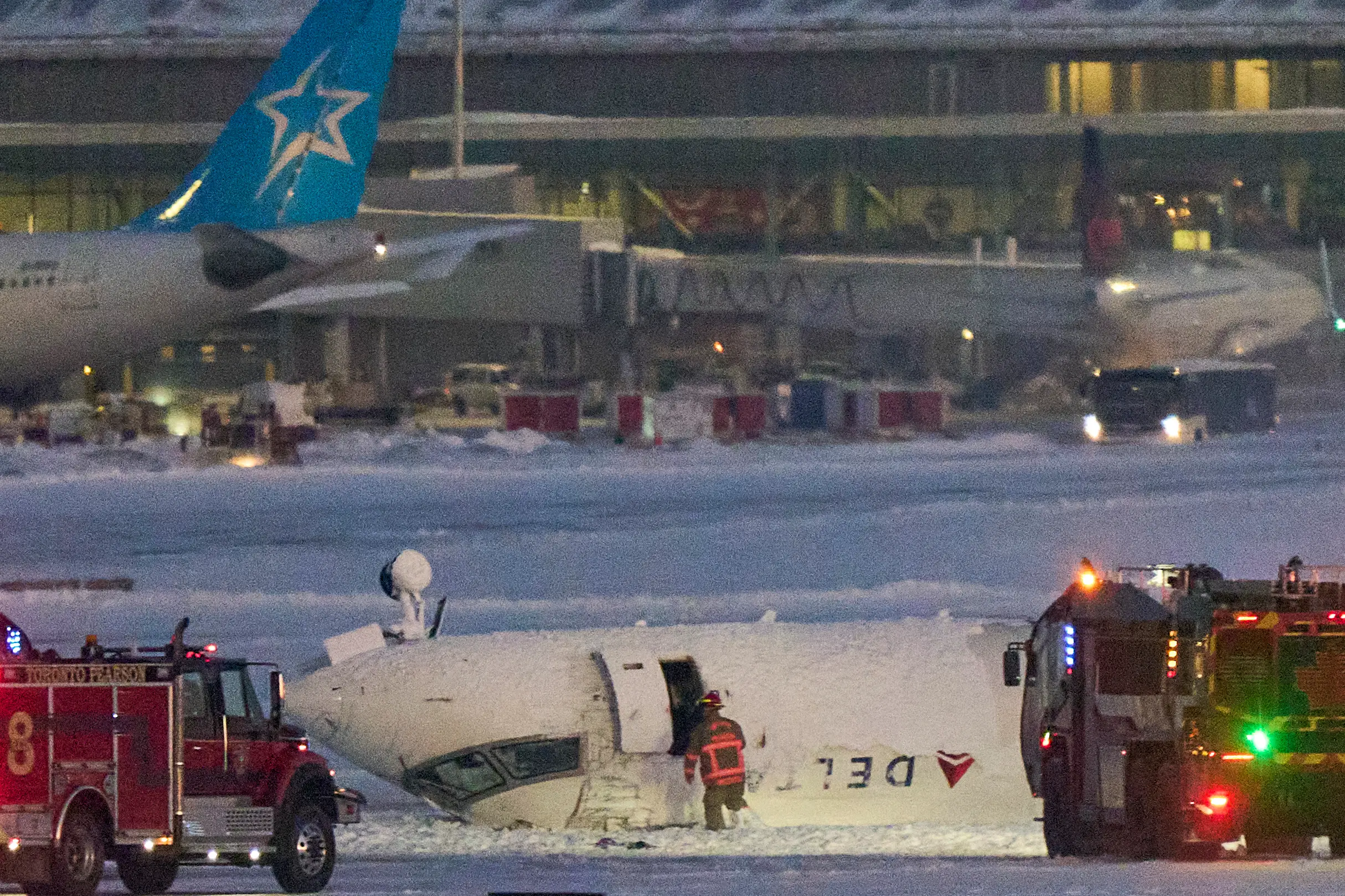 The Delta Airlines plane ended up flipped on its roof (GEOFF ROBINS/AFP via Getty Images) 