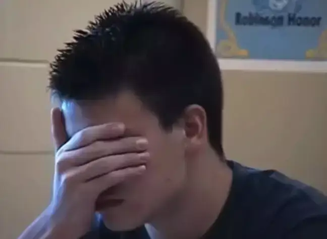 A student was filmed holding his head in his hands.