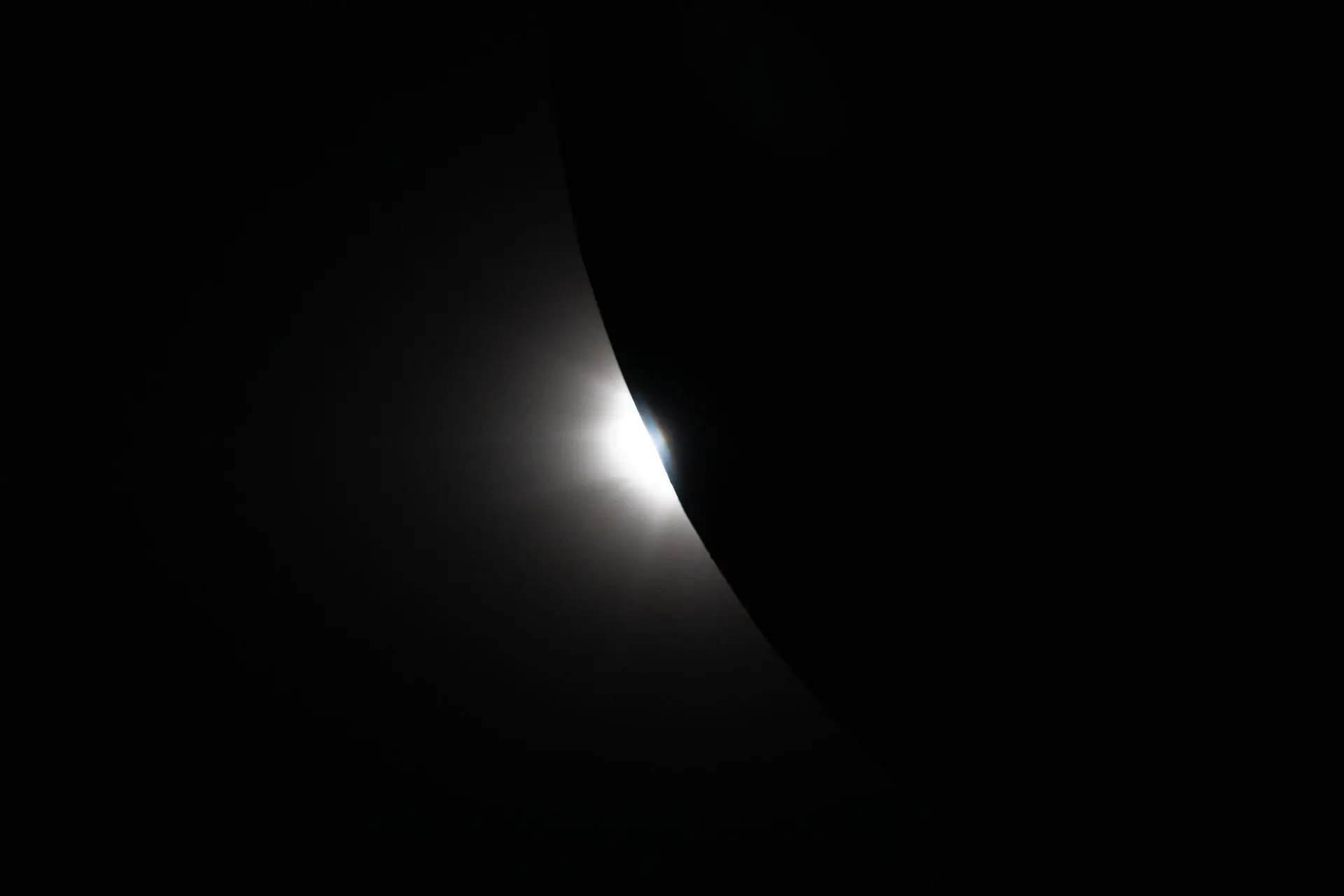The Sun beginning to peek out from behind the Moon (NASA)