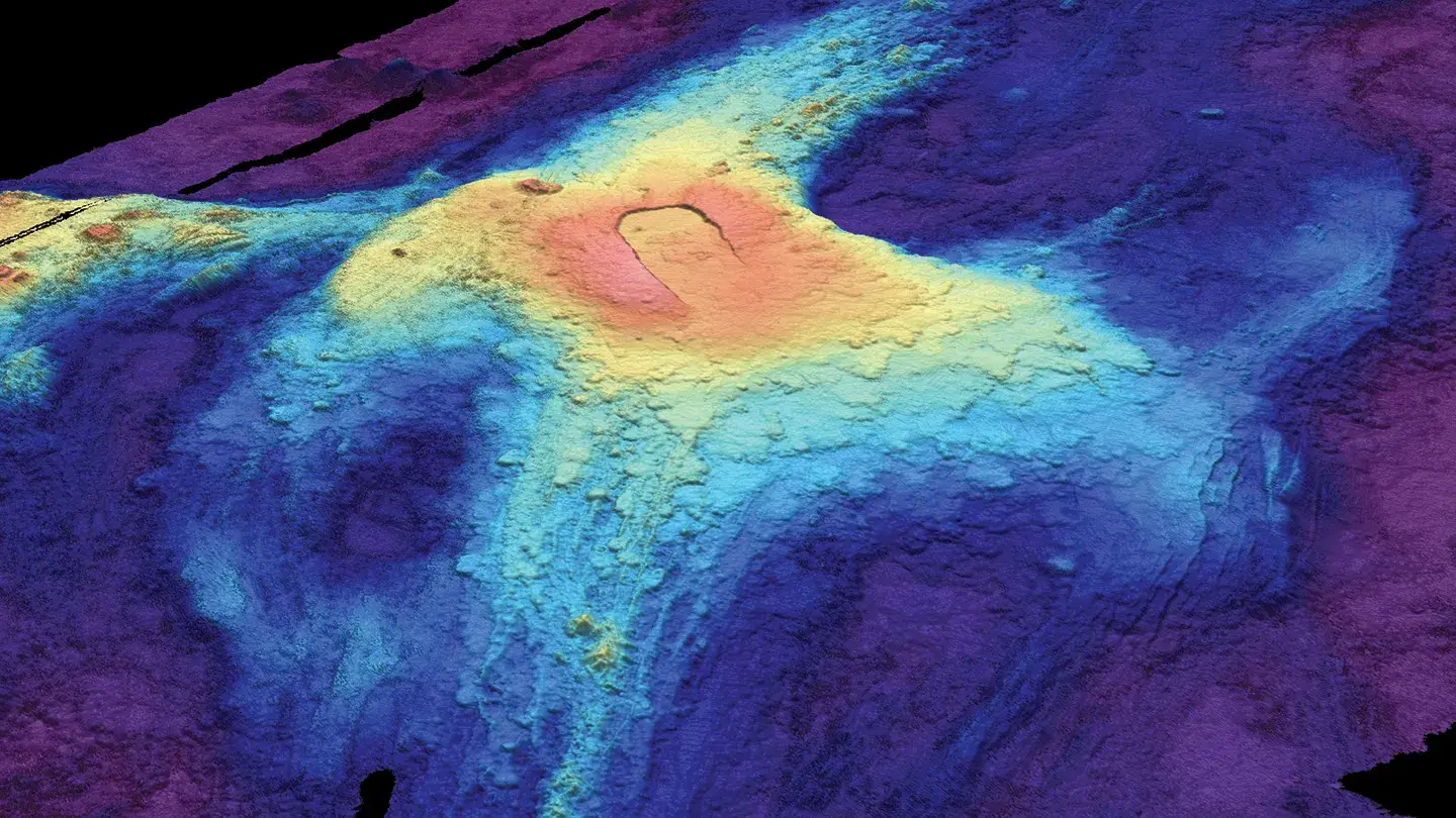 A 3-D bathymetric seafloor map of Axial Seamount in July 2014 shows lava flows from previous eruptions. Red indicates lava at the highest elevation above the seafloor, while dark blue at the edges shows where lava flow was thinnest (Susan Merle/Oregon State University)