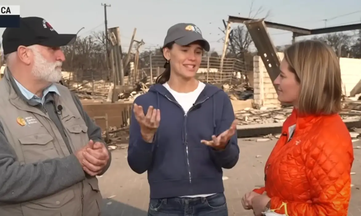 The trio were surrounded by buildings ruined by the fires (YouTube/ MSNBC)
