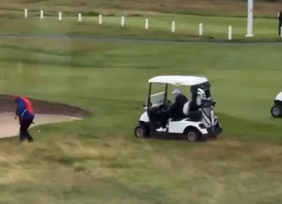 The caddy can be seen 'dropping' the ball ahead of Trump (Twitter)