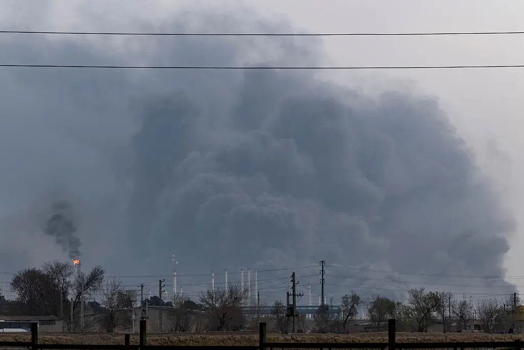 The sky is darkened by oil-soot residue from Tehran's petroleum storage facilities (Morteza Nikoubazl/NurPhoto via Getty Images)