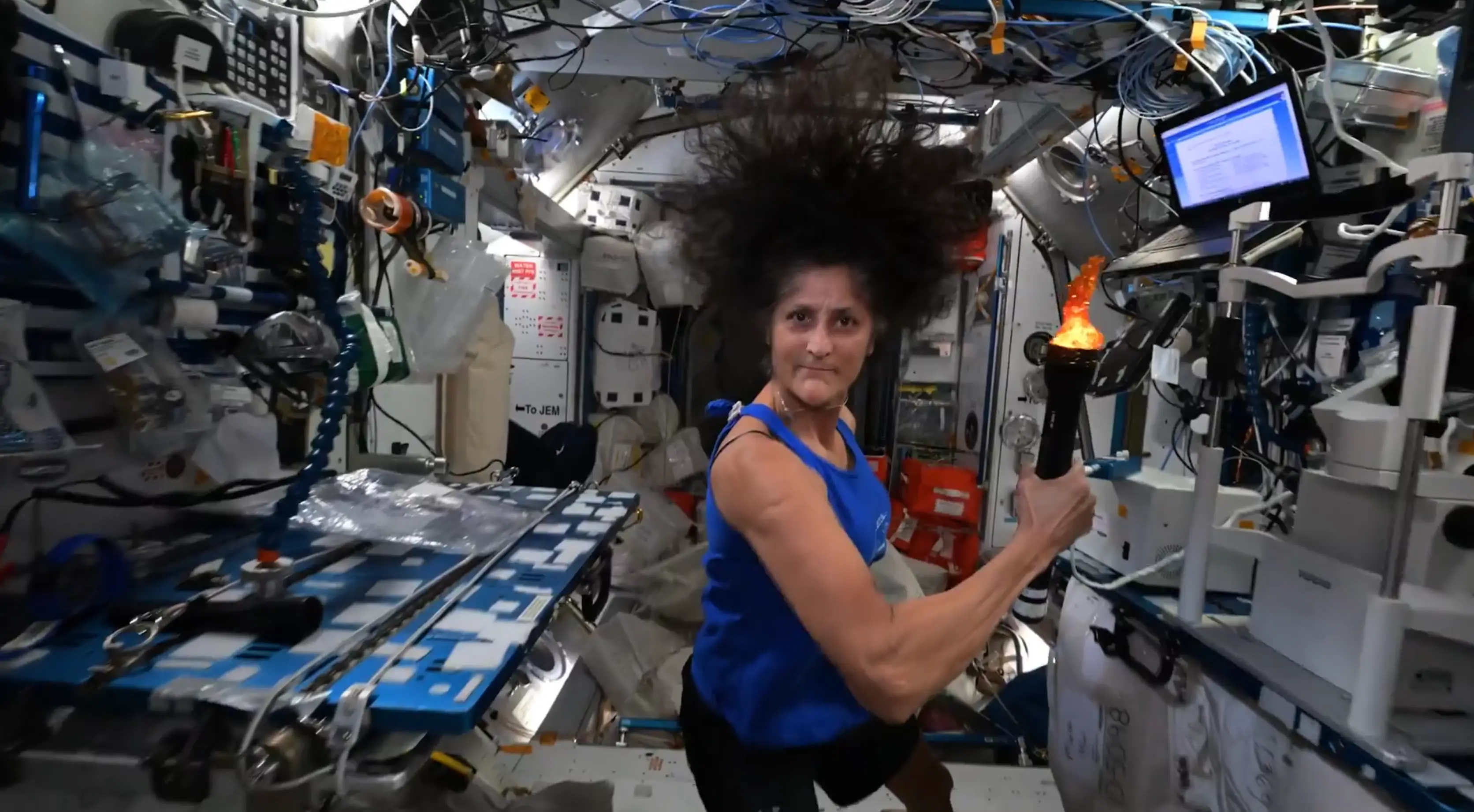 Williams holds the 'Olympic torch' onboard the ISS. (NASA)