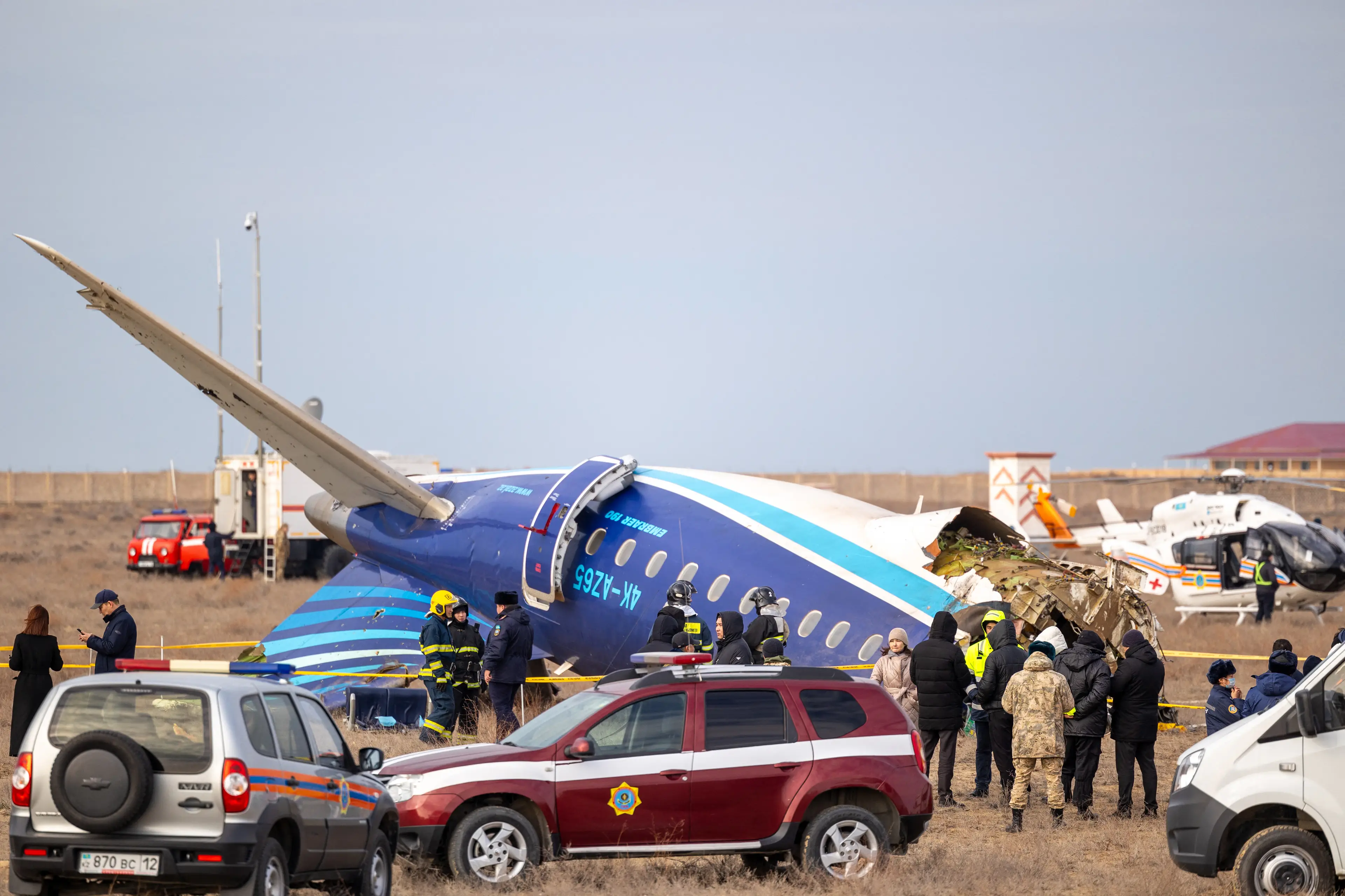 Emergency workers descended on the crash site (ISSA TAZHENBAYEV/AFP via Getty Images)