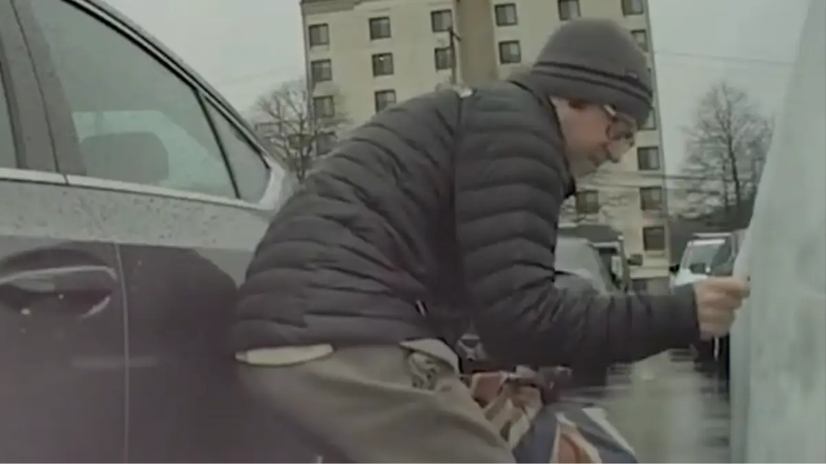 Awkward moment Tesla owner confronts man allegedly caught drawing swastika on car