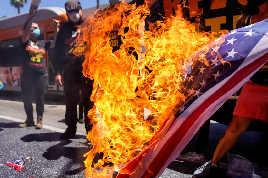 Protesters set fire to a flag near Trump's star on the Hollywood Walk of Fame in Los Angeles in July (Kent Nishimura / Los Angeles Times via Getty Images)