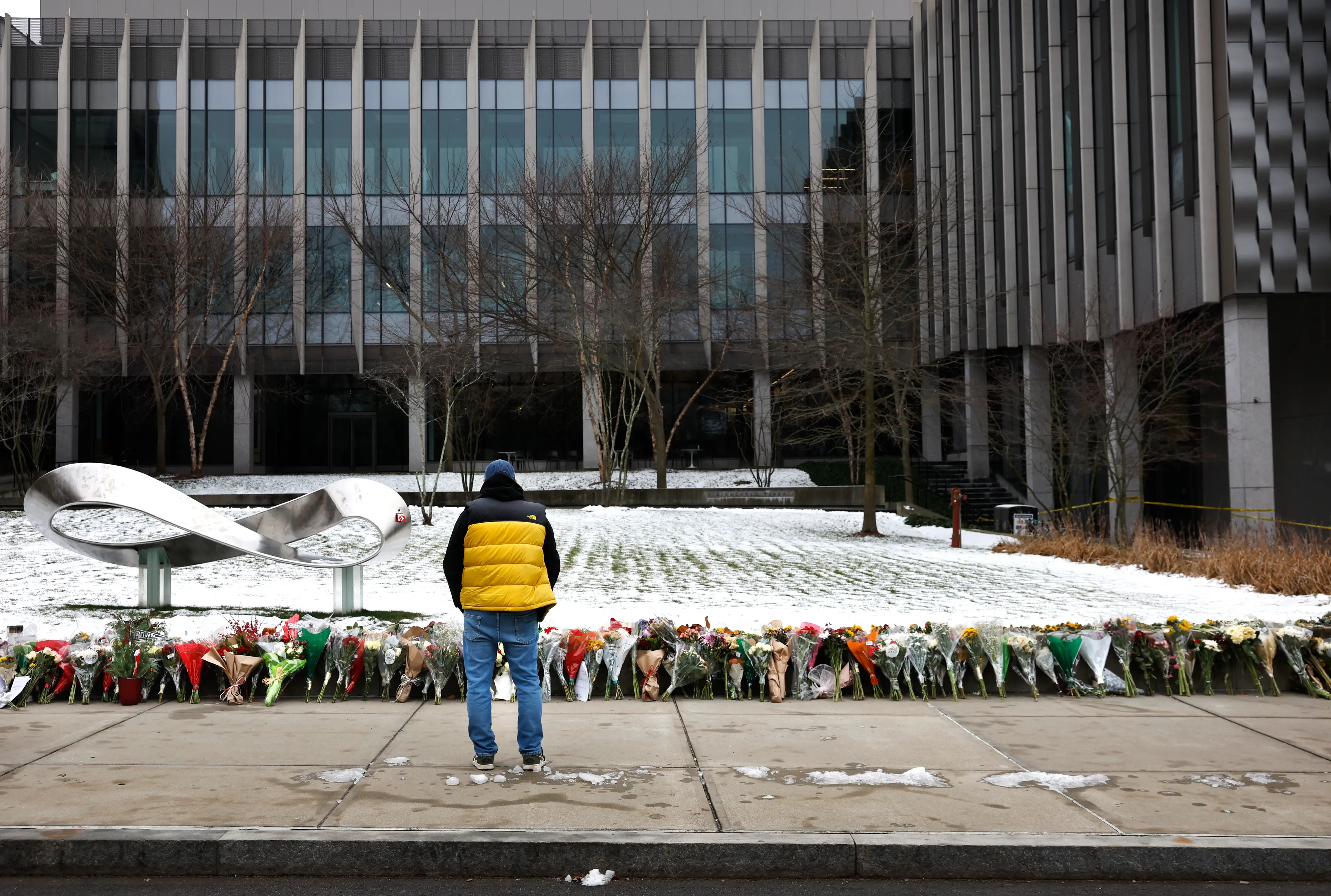 Hundreds of flowers were left at Brown University in tribute to the students killed on Saturday ( Craig F. Walker/The Boston Globe via Getty Images)