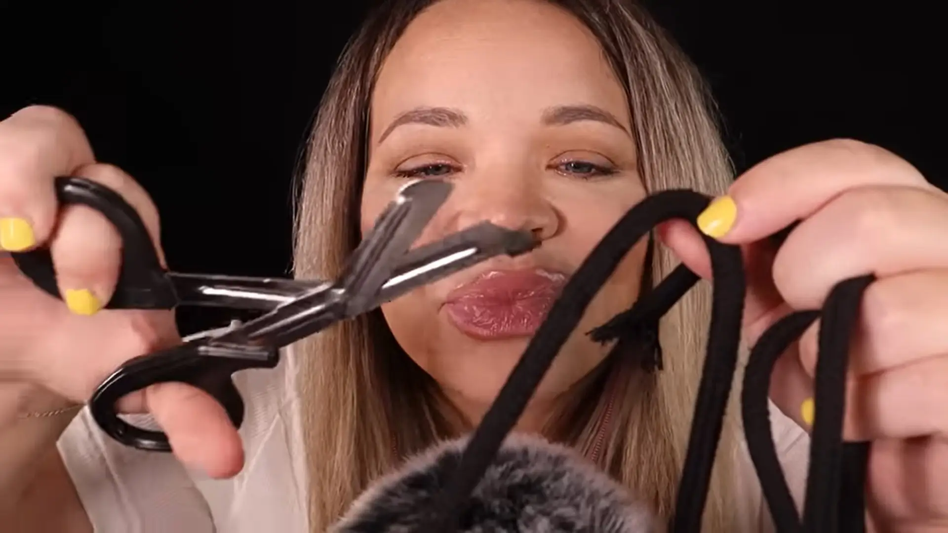 The YouTuber cut a piece of string like an umbilical cord as part of the ASMR.