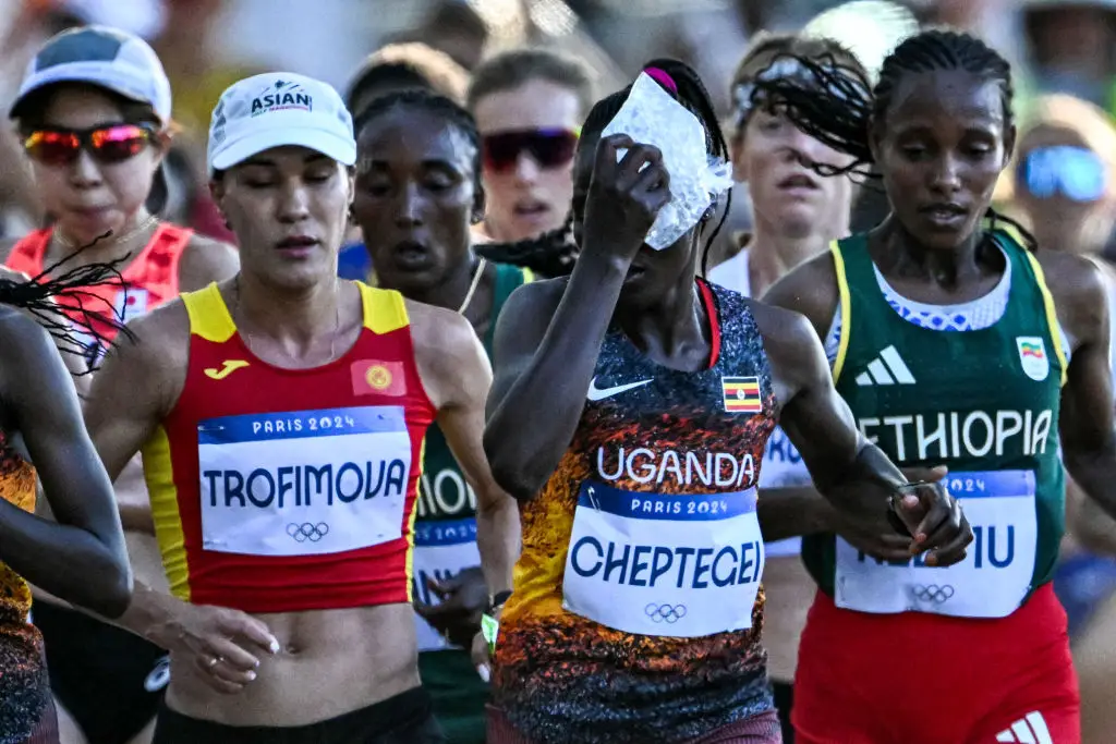 Uganda's Rebecca Cheptegei applies an ice bag on her head at the Paris 2024 Olympics (KIRILL KUDRYAVTSEV/AFP via Getty Images)