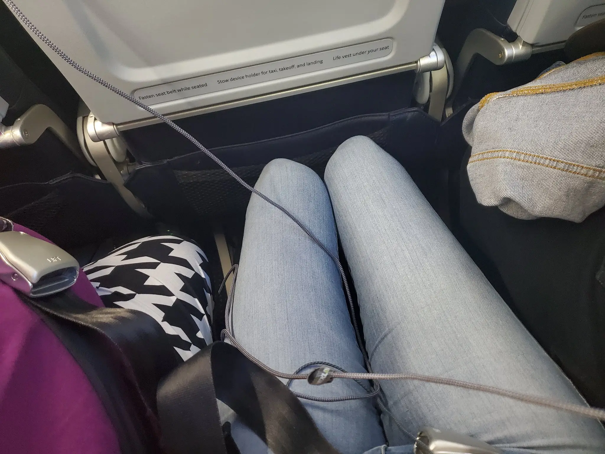 A woman has received compensation after being sat next to two overweight people on a plane.