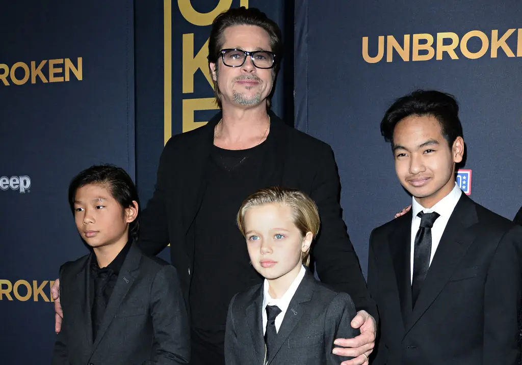Brad Pitt with Pax, Shiloh and Maddox in 2014 (ROBYN BECK/AFP via Getty Images)