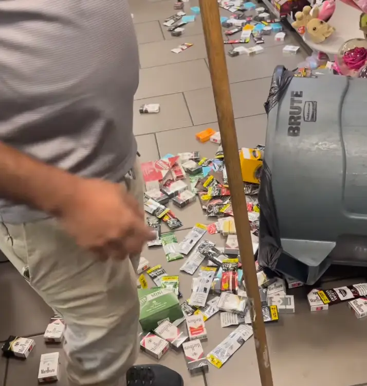 The cigarettes the suspect attempted to steal scattered on the floor as he was beaten.