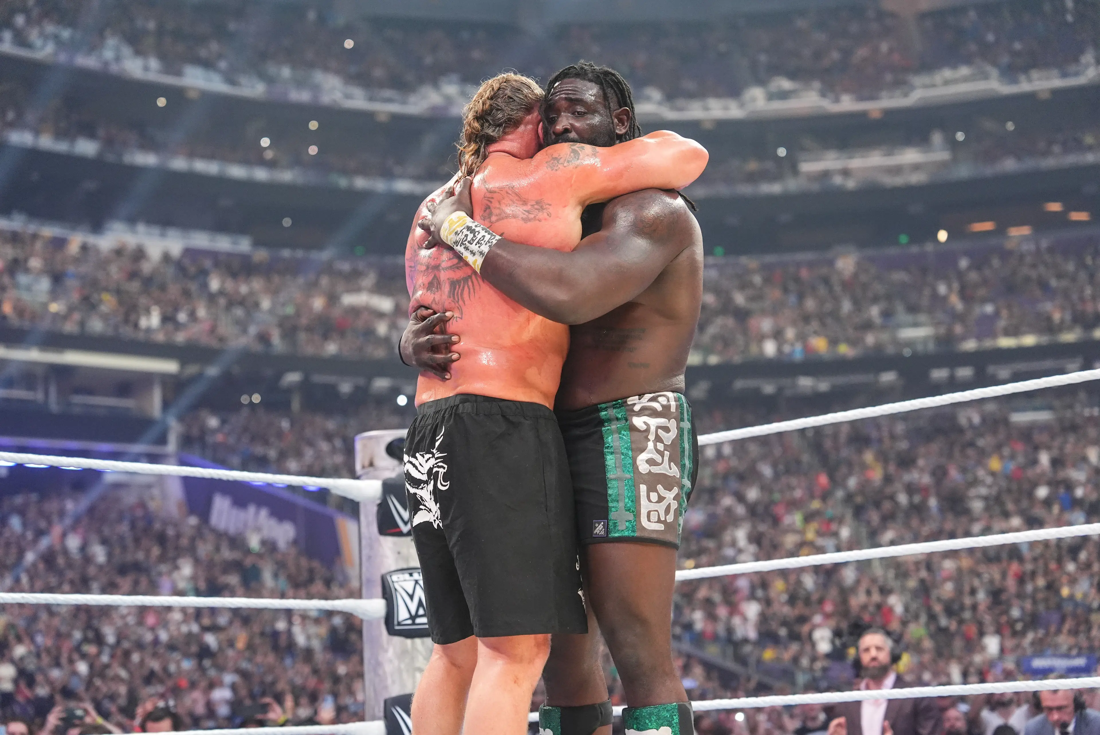 Brock embraces Oba Femi following his defeat (Georgiana Dallas/WWE via Getty Images)