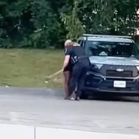 The officer was seen sharing a passionate kiss with the woman.