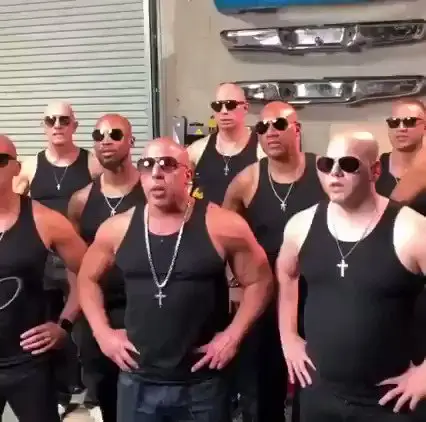 The group of bald men say 'family' in unison in this meme.