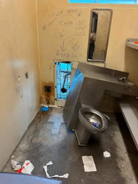 The inmates wrote 'To easy LOL' on the wall, while the picture reveals how the criminals escaped through the back of the toilet (Orleans Parish Sheriff's Office)