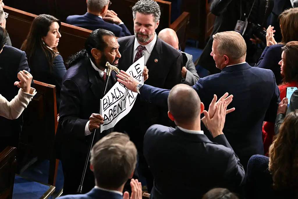 Others attempted to block Green's sign from view (ANDREW CABALLERO-REYNOLDS / AFP via Getty Images)