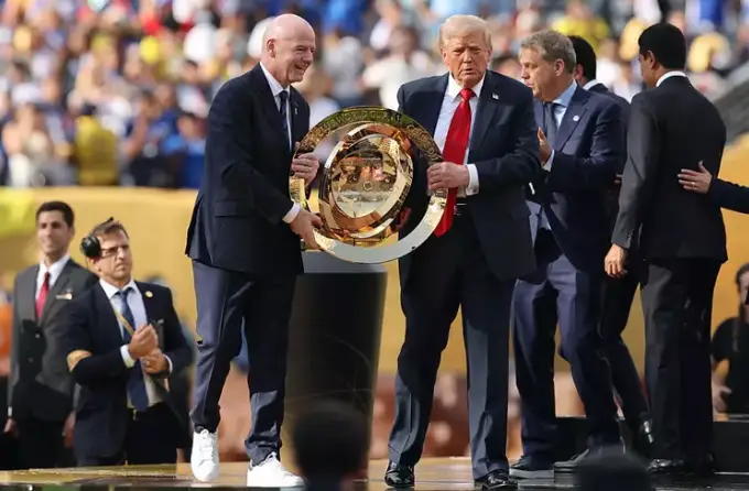 Trump handed the team the trophy following their victory in the final (Alex Grimm/Getty Images)