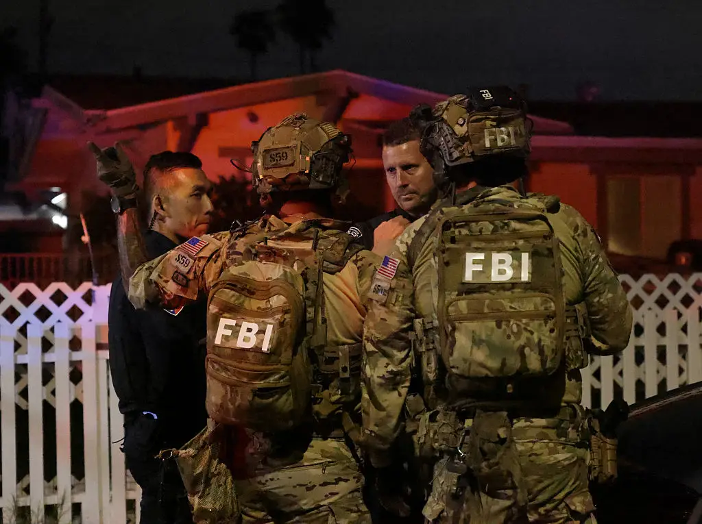 FBI agents pictured storming the house of suspected shooter Cole Tomas Allen following the shooting (Robbin Goddard / Los Angeles Times via Getty Images)
