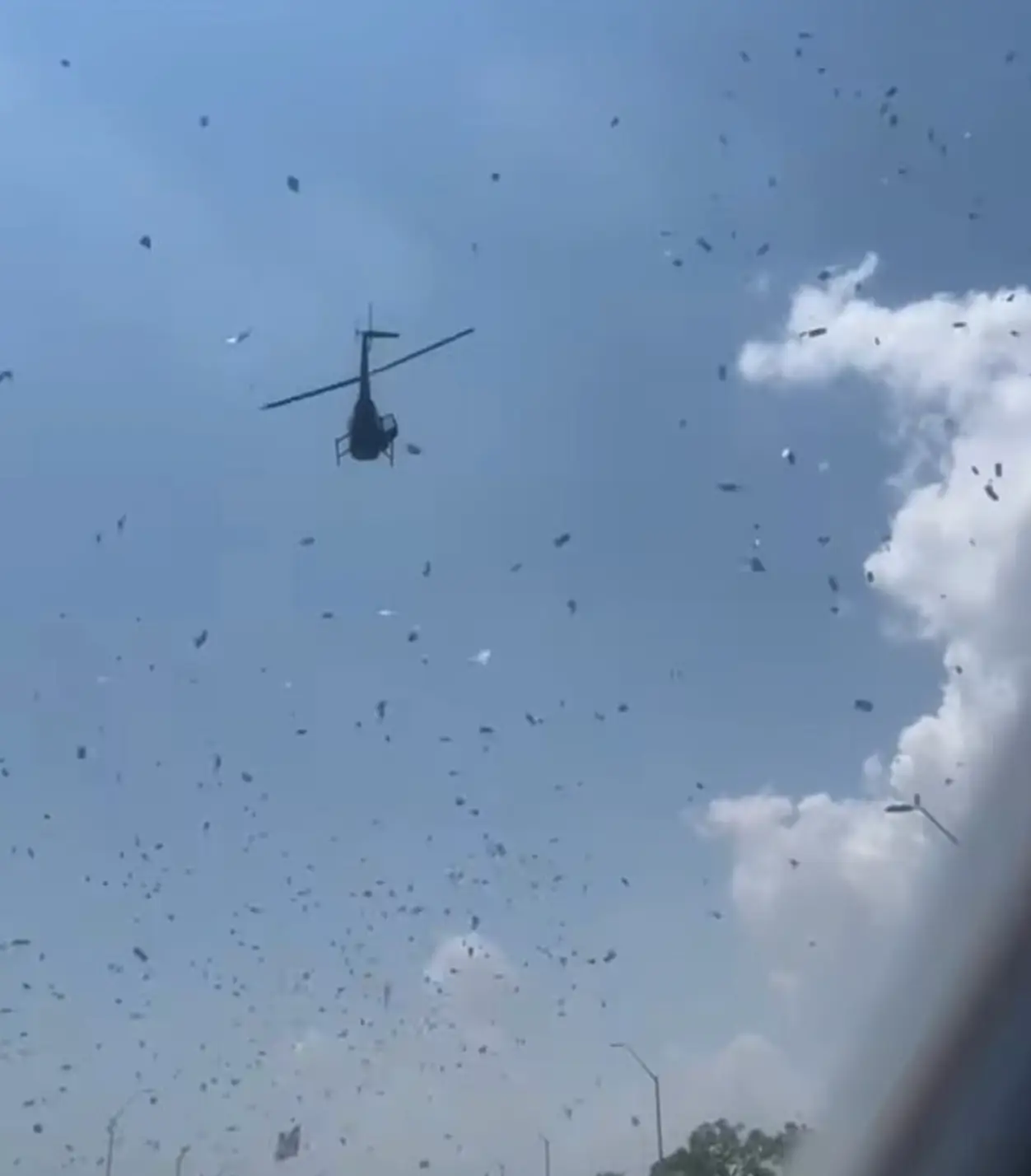 The helicopter hovers as money and petals shower the Detroit streets (Facebook/Crystal Perry)