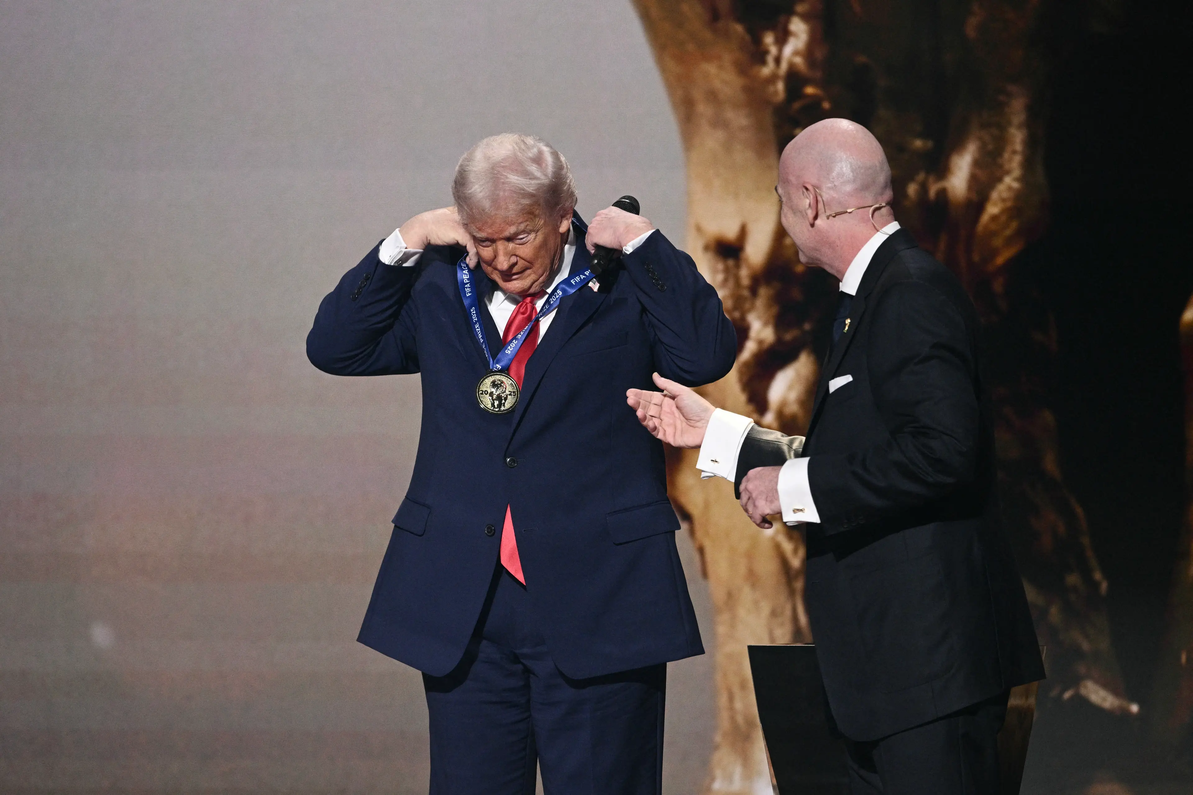 Trump had to put the medal on himself (Photo by Brendan SMIALOWSKI / AFP via Getty Images)