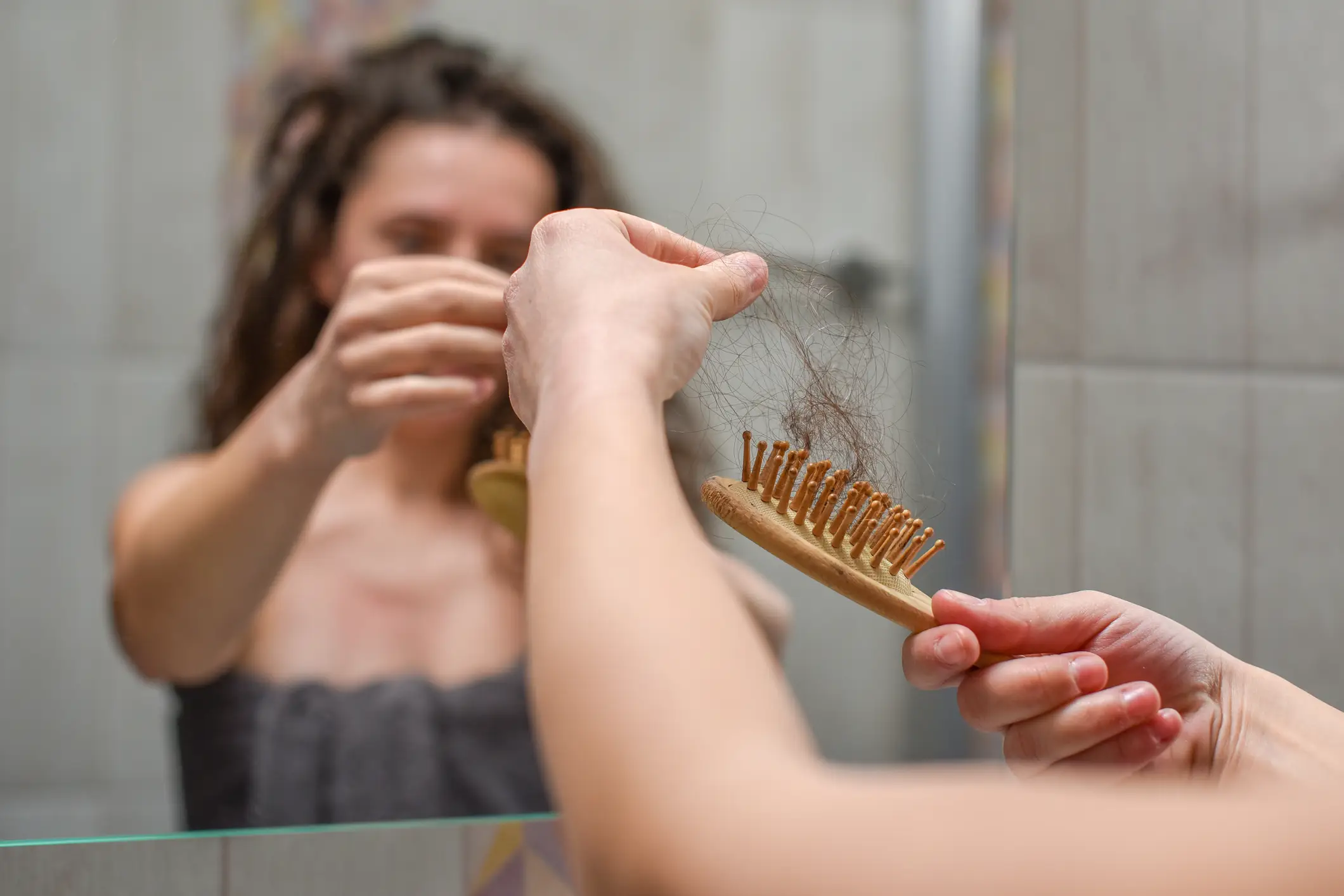 Women are more likely to lose the fullness in their hair (Getty Images)