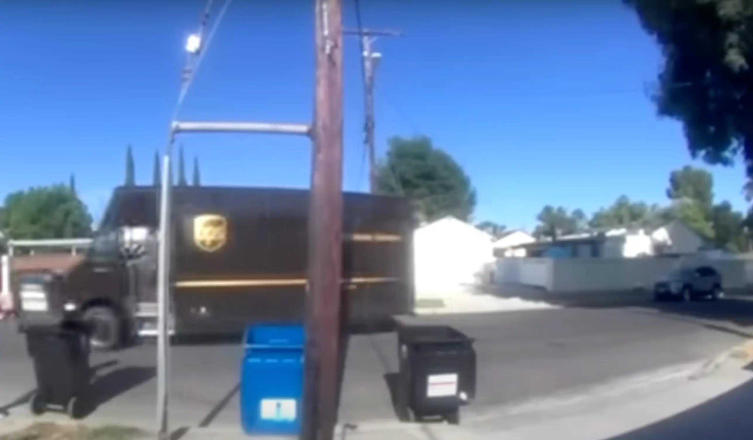 The UPS delivery driver tossed the package over the fence before driving off. (KCAL News)