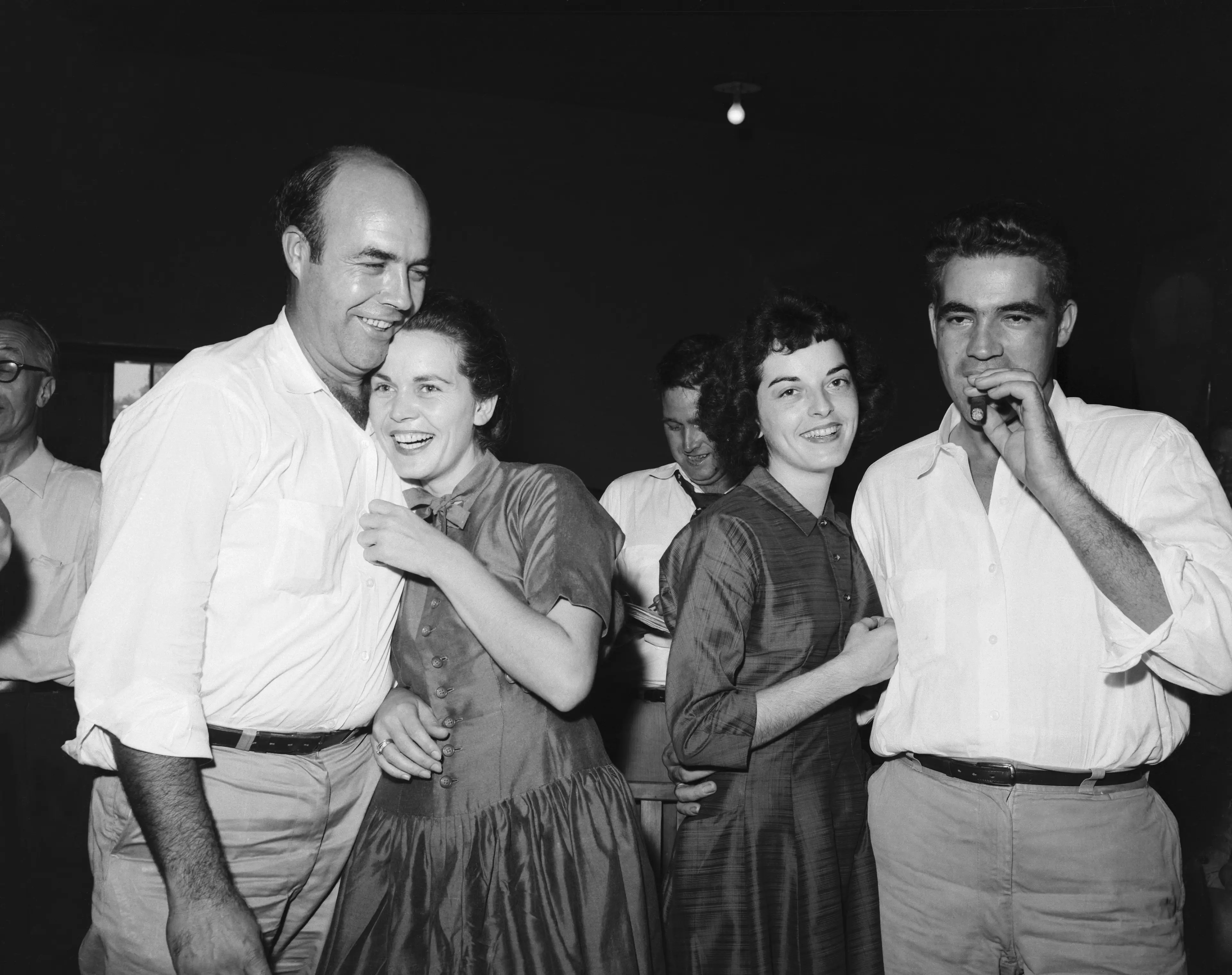 Roy Bryant (right), smokes a cigar as his wife happily embraces him alongside his half brother, J.W. Milam and his wife after being acquitted (Getty Images)