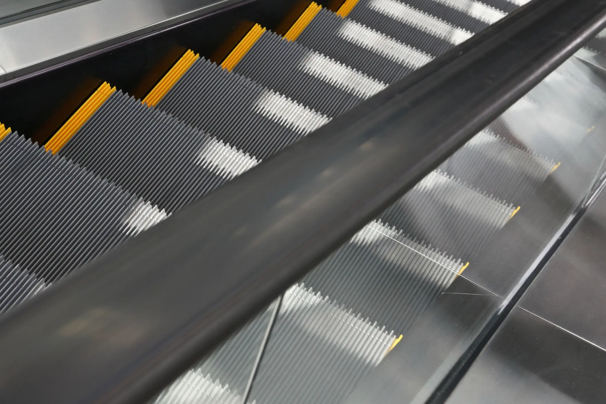 Handrails on an escalator actually move at a faster rate than steps for an important reason (Getty stock)