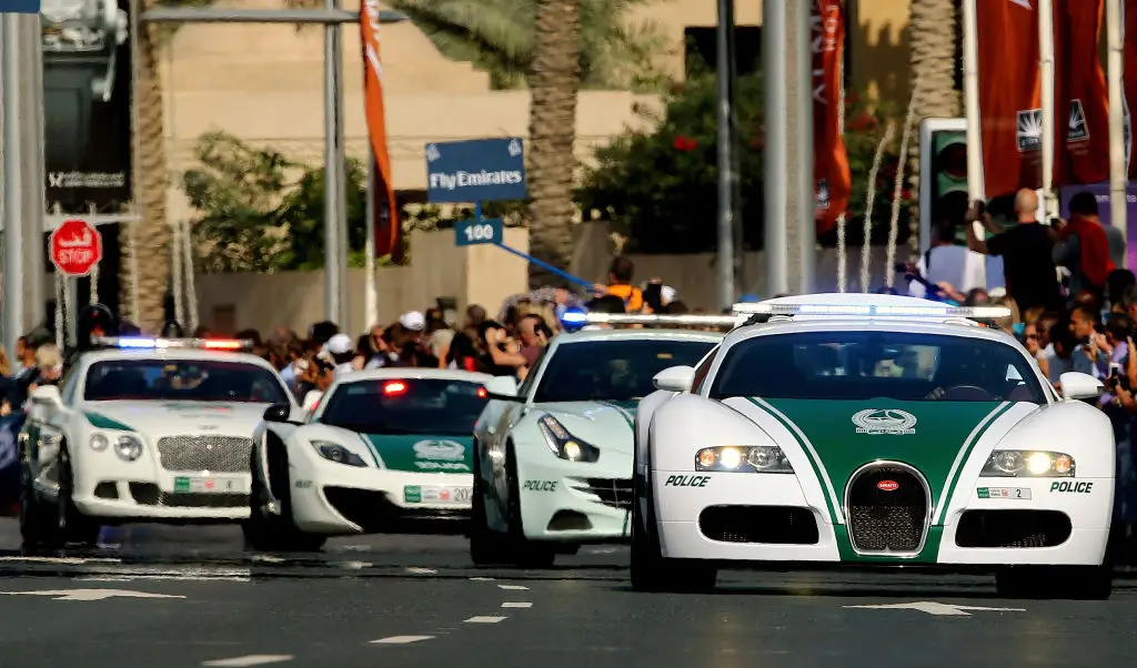 A Dubai police Bugatti leads a convoy of police vehicles, including a Porsche-Panamera, a Lamborghini Aventador and a Bentley (MARWAN NAAMANI/AFP via Getty Images)