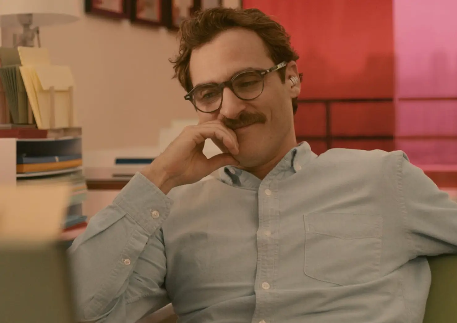 Joaquin Phoenix's character gets VERY acquainted with Scarlett Johansson's voice... if you know what I mean. (Warner Bros.)