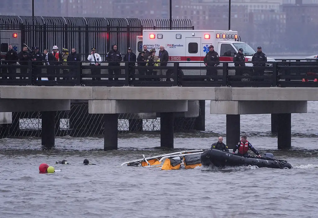 Police and firefighters work on the site after the chopper crashed into the Hudson River near lower Manhattan, on Thursday (Lokman Vural Elibol/Anadolu via Getty Images)