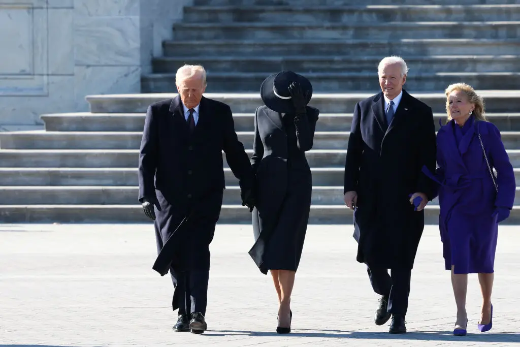 Body language experts have also pointed out Melania's 'strange' outfit choice (Joe Raedle/Getty Images)